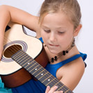 young girl plays guitar